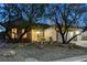 Inviting front exterior with mature trees, manicured landscaping, and a well-lit entrance at 1637 Wellington Springs Ave, Henderson, NV 89052