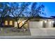 Charming single-story home with a well-manicured yard and a three-car garage, captured at twilight at 1637 Wellington Springs Ave, Henderson, NV 89052