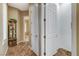 Hallway featuring wood floors, base trim, and a decorative cabinet with glass shelving at 1637 Wellington Springs Ave, Henderson, NV 89052