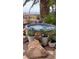 Relaxing hot tub surrounded by lush plants and flowers, perfect for outdoor enjoyment at 1637 Wellington Springs Ave, Henderson, NV 89052