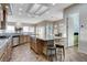 Bright and open kitchen with a large island, granite countertops, and views to the breakfast nook at 1637 Wellington Springs Ave, Henderson, NV 89052