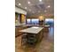Open kitchen with granite counters, a large center island, and mountain views at 1637 Wellington Springs Ave, Henderson, NV 89052