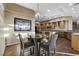 This breakfast nook features a glass table with views of the expansive kitchen with an open floor plan at 1637 Wellington Springs Ave, Henderson, NV 89052