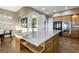Kitchen features a large island, stainless steel appliances, and wood-look floors at 1637 Wellington Springs Ave, Henderson, NV 89052