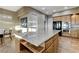 The kitchen features wood floors, granite counters, a large island, and stainless steel appliances at 1637 Wellington Springs Ave, Henderson, NV 89052