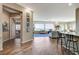 Spacious living room featuring tile flooring, large picture windows, and views to the kitchen at 1637 Wellington Springs Ave, Henderson, NV 89052