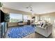 Bright living room featuring a ceiling fan, wood floors, and large windows with great outdoor views at 1637 Wellington Springs Ave, Henderson, NV 89052
