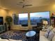 Bright living room with large windows showcasing city views, comfortable seating, and stylish decor at 1637 Wellington Springs Ave, Henderson, NV 89052