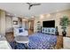 Spacious living room with modern decor featuring a stylish blue rug, entertainment center and a ceiling fan at 1637 Wellington Springs Ave, Henderson, NV 89052