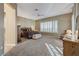Large bedroom with neutral walls and carpet, ceiling fan and window with shutter blinds at 1637 Wellington Springs Ave, Henderson, NV 89052