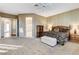 Spacious bedroom with large bed, furniture, and views to the bedroom's ensuite bathroom at 1637 Wellington Springs Ave, Henderson, NV 89052