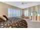 Bedroom with neutral walls and carpet, ceiling fan and window with shutter blinds at 1637 Wellington Springs Ave, Henderson, NV 89052