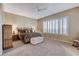 Bedroom with neutral walls and carpet, ceiling fan and window with shutter blinds at 1637 Wellington Springs Ave, Henderson, NV 89052