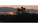 Night view of the city lights with desert mountains in the background at 1637 Wellington Springs Ave, Henderson, NV 89052
