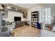 Home office with built-in desk, shelving, hardwood floors, plantation shutters and comfortable seating at 1637 Wellington Springs Ave, Henderson, NV 89052