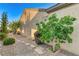Side yard features a stone pathway, mature trees, and low-maintenance desert landscaping at 1637 Wellington Springs Ave, Henderson, NV 89052