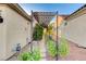 Covered walkway adorned with green foliage and decorative metalwork enhances outdoor charm at 1637 Wellington Springs Ave, Henderson, NV 89052