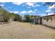 Large backyard featuring a partially covered sunroom and mature trees, perfect for entertaining at 1674 Palma Vista Ave, Las Vegas, NV 89169