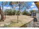 Wide backyard with sparse grass, a mature tree, and a sunroom at 1674 Palma Vista Ave, Las Vegas, NV 89169