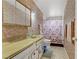 Traditional bathroom featuring floral wallpaper, shower/tub, vanity and medicine cabinet at 1674 Palma Vista Ave, Las Vegas, NV 89169