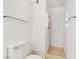 All-white bathroom featuring standing shower, standard toilet, and hardware at 1674 Palma Vista Ave, Las Vegas, NV 89169