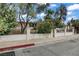 Charming front yard featuring mature trees and colorful bushes at 1674 Palma Vista Ave, Las Vegas, NV 89169