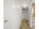 Hallway with carpeted flooring, neutral walls, and multiple doors offers passage to various rooms at 1674 Palma Vista Ave, Las Vegas, NV 89169
