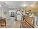 Bright kitchen featuring white appliances, wood cabinets, and an open layout to the connected living spaces at 1674 Palma Vista Ave, Las Vegas, NV 89169