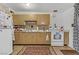 Traditional kitchen with appliances, white cabinets, and tile backsplash offers a functional cooking space at 1674 Palma Vista Ave, Las Vegas, NV 89169