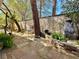 Backyard landscaping with stone pathway, mature trees, and a decorative water feature at 1753 Tanner Cir, Henderson, NV 89012