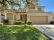 Charming two-story home with a well-maintained lawn and mature landscaping, enhancing curb appeal at 1753 Tanner Cir, Henderson, NV 89012