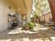 Covered patio area with stone flooring, potted plants, and access to the landscaped backyard at 1753 Tanner Cir, Henderson, NV 89012