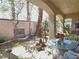 Covered patio with a round glass-topped table and chairs, set in a landscaped backyard at 1753 Tanner Cir, Henderson, NV 89012