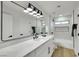 Modern bathroom featuring sleek black hardware, a large mirror, and a soaking tub with tile surround at 193 Jeri Dr, Henderson, NV 89074