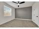 Well lit primary bedroom features a large window, ceiling fan, and neutral carpeting at 193 Jeri Dr, Henderson, NV 89074