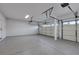 Spacious two car garage with epoxy flooring, finished white walls, and an automatic door at 193 Jeri Dr, Henderson, NV 89074