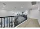 Upstairs hallway with carpeted floors and wrought iron staircase leading to the living room at 193 Jeri Dr, Henderson, NV 89074