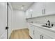 Functional laundry room with white cabinetry, modern sink, and plenty of counter space for folding at 193 Jeri Dr, Henderson, NV 89074