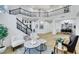 Bright, open-concept living room with soaring ceilings, stylish decor, and black iron staircase at 193 Jeri Dr, Henderson, NV 89074