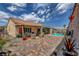 Inviting backyard with covered patio, comfortable seating, brick pavers, and refreshing private pool at 2092 Wildwood Lake Street, Henderson, NV 89052
