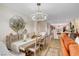 Bright dining room features a modern chandelier over a wooden table and chairs at 2092 Wildwood Lake Street, Henderson, NV 89052