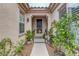Inviting front entrance adorned with decorative plants and charming decor at 2092 Wildwood Lake Street, Henderson, NV 89052