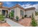 Charming home entrance with tile walkway and an array of potted plants at 2092 Wildwood Lake Street, Henderson, NV 89052