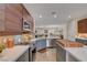Kitchen featuring wood-look flooring, island, stone countertops, and modern stainless appliances at 2092 Wildwood Lake Street, Henderson, NV 89052