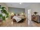 Serene main bedroom offers neutral tones, wood floors, comfortable bed, and modern accents at 2092 Wildwood Lake Street, Henderson, NV 89052