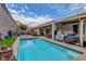 Backyard pool provides a cool respite, alongside a covered patio with dining and barbecue areas at 2092 Wildwood Lake Street, Henderson, NV 89052