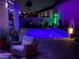 Inviting outdoor space featuring a private pool with colorful lighting and ample seating for relaxing in the evening at 2092 Wildwood Lake Street, Henderson, NV 89052