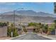 Elevated street view of home with neat front yard landscaping and attractive mountain views at 2092 Wildwood Lake Street, Henderson, NV 89052