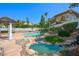 Lush backyard oasis with a sparkling pool, rock features, and mature landscaping, ideal for outdoor entertaining at 2097 Eaglepath Cir, Henderson, NV 89074