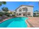Stunning backyard featuring a sparkling pool, lush greenery, and a serene patio area, perfect for outdoor enjoyment at 2097 Eaglepath Cir, Henderson, NV 89074